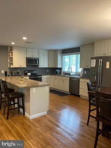 a kitchen with a sink cabinets and appliances