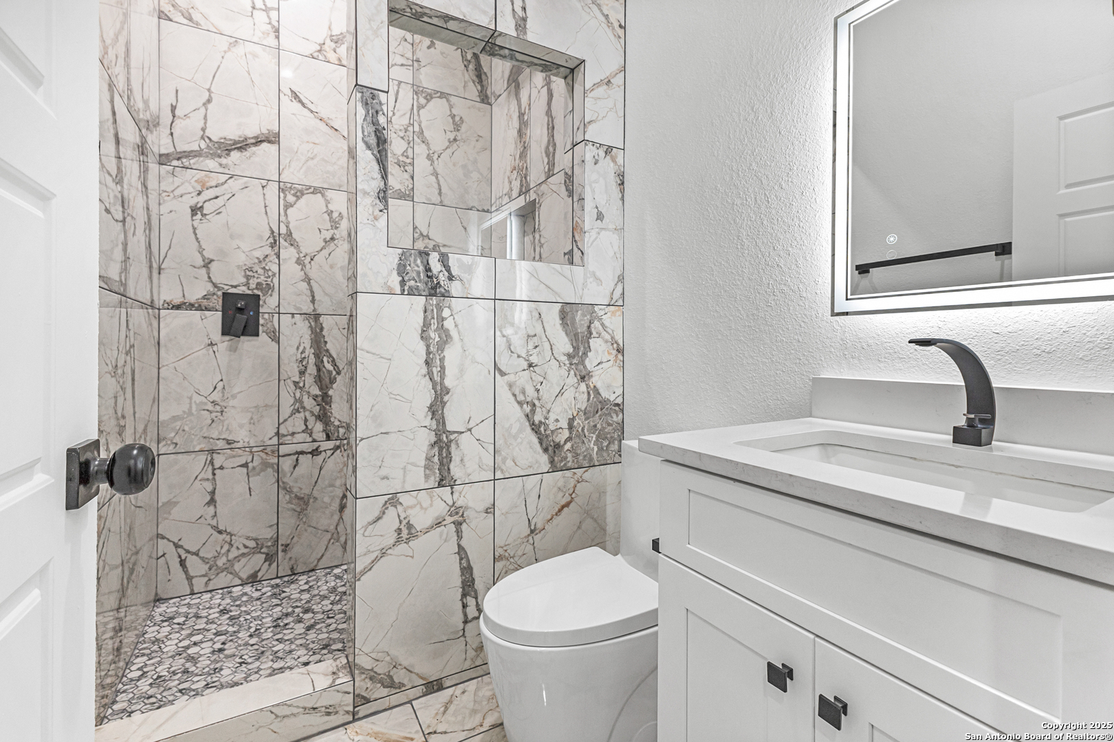 133 Flor Del Sol Road San Antonio, TX 78264 - Photo 20 of 28 a bathroom with a granite countertop toilet sink and shower
