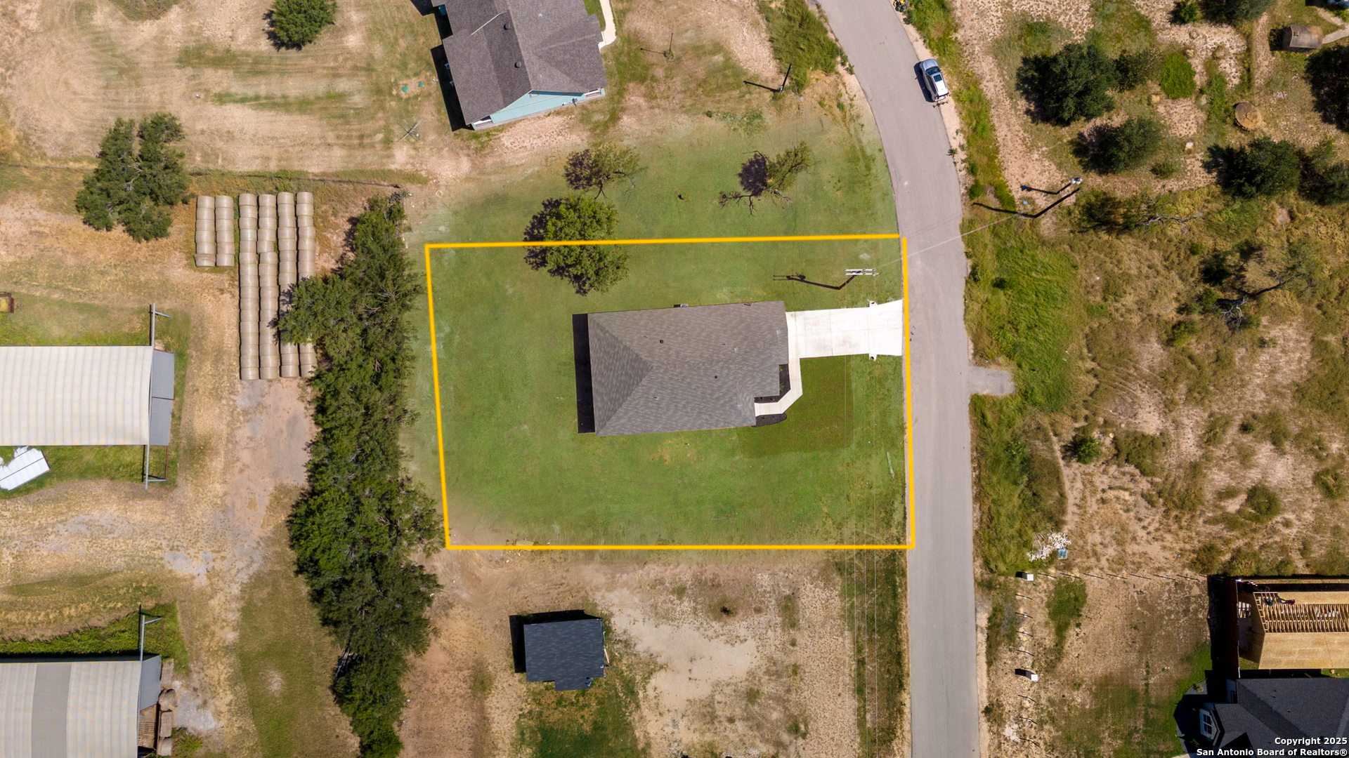 133 Flor Del Sol Road San Antonio, TX 78264 - Photo 28 of 28 an aerial view of a house with a yard