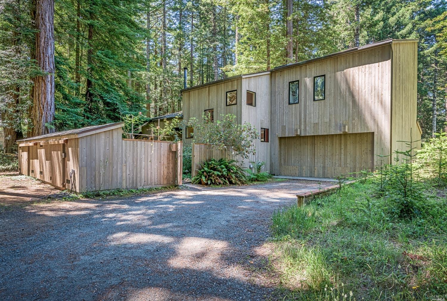 a view of backyard of house with wooden fence