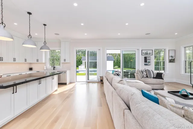 a bathroom with a granite countertop sink toilet a mirror and shower