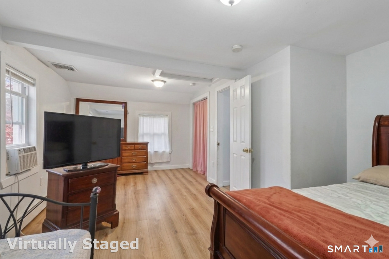 37 Manhan Street Waterbury, CT 06710 - Photo 11 of 19 a bedroom with a bed and a flat screen tv
