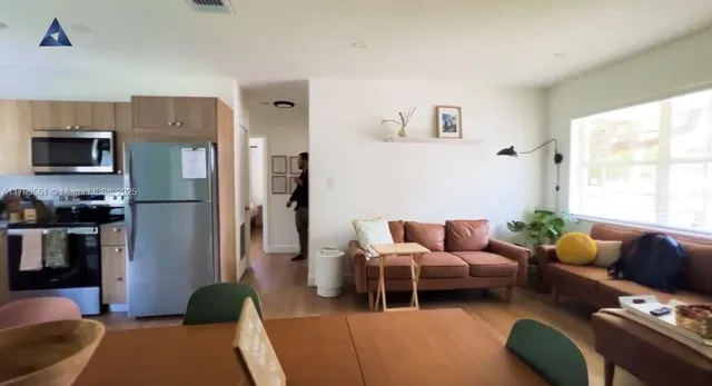 a living room with furniture fireplace and a window