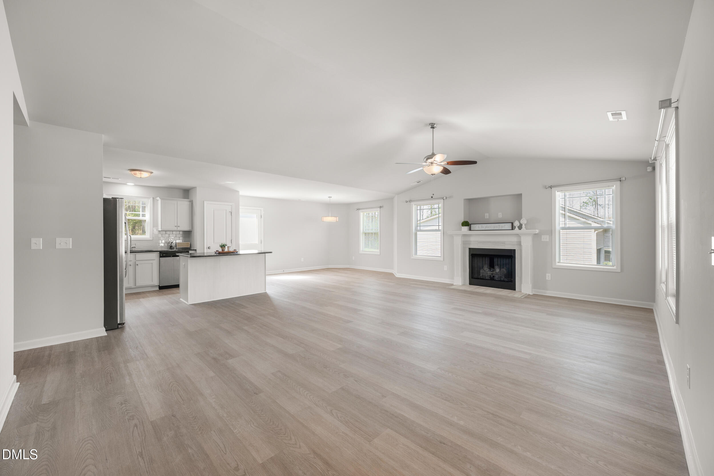 67 Dale Ridge Drive Princeton, NC 27569 - Photo 2 of 22 an empty room with kitchen and fireplace