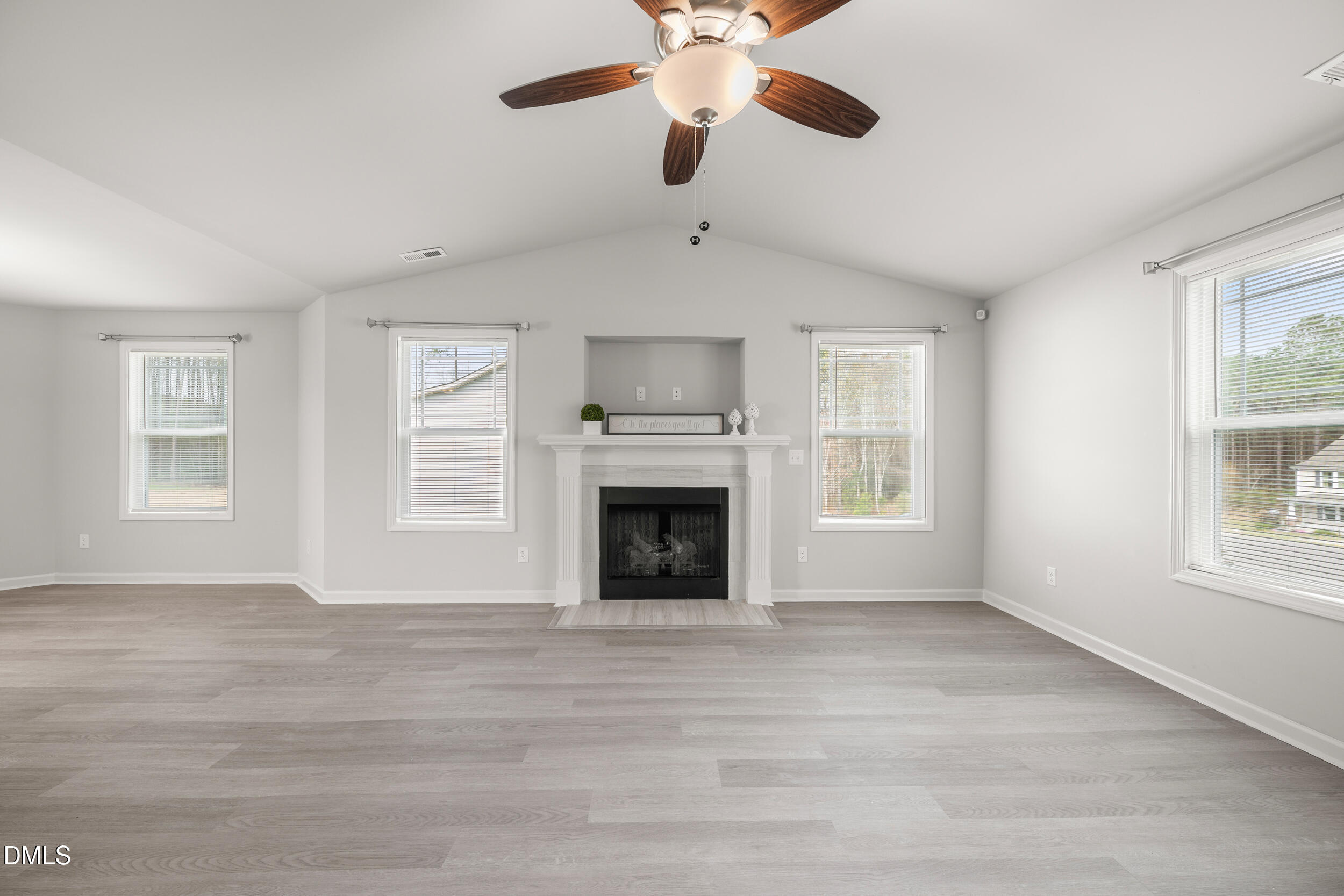 67 Dale Ridge Drive Princeton, NC 27569 - Photo 3 of 22 a view of an empty room with wooden floor fireplace and a window