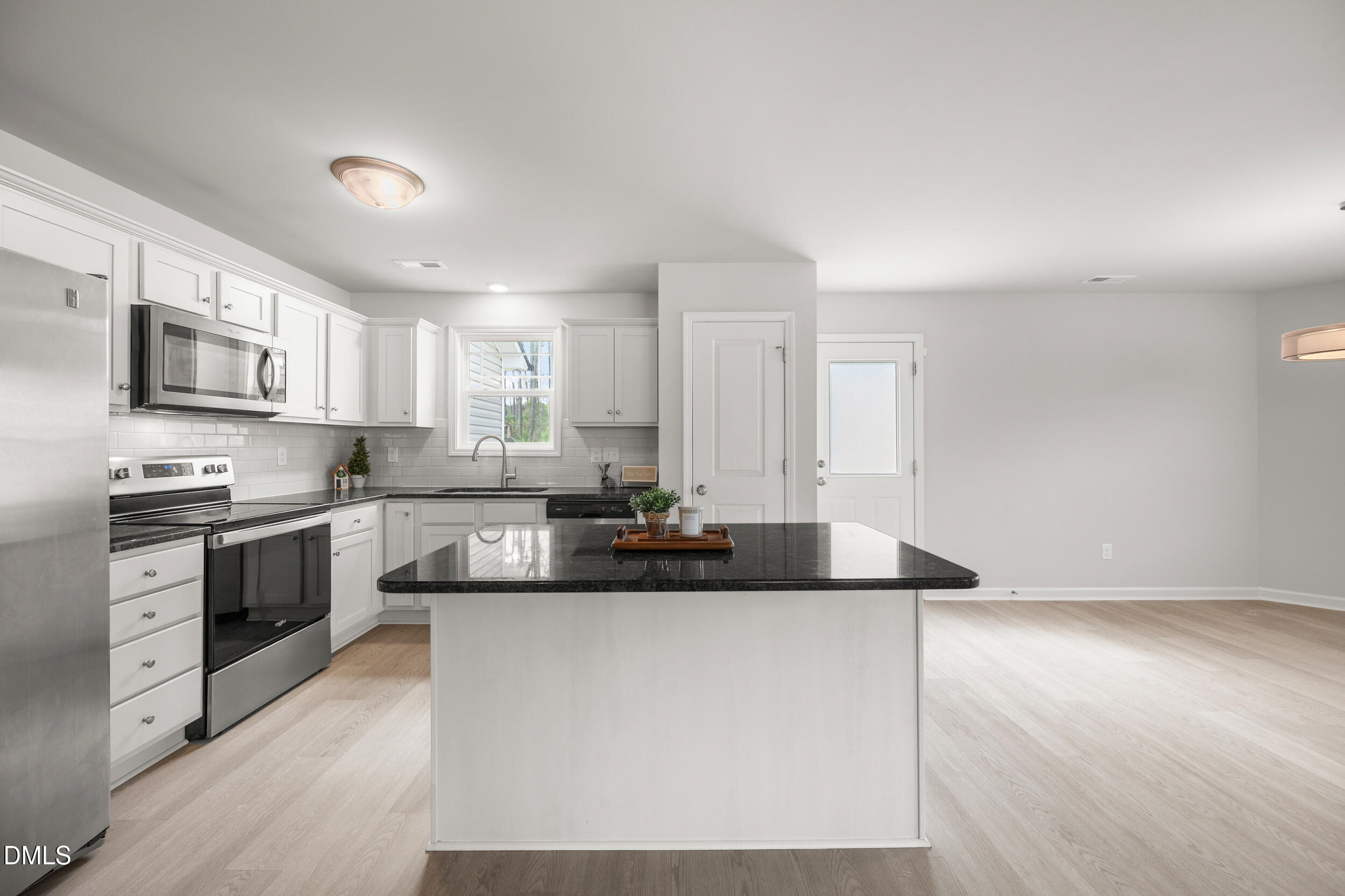 67 Dale Ridge Drive Princeton, NC 27569 - Photo 5 of 22 a kitchen with stainless steel appliances granite countertop a sink and a stove
