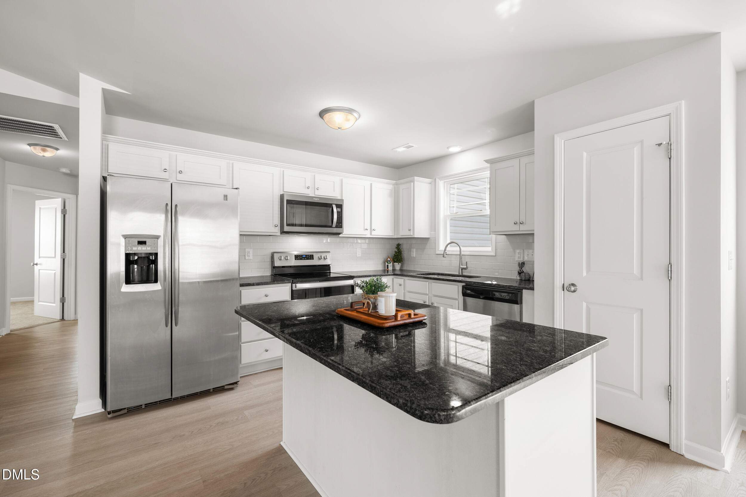 67 Dale Ridge Drive Princeton, NC 27569 - Photo 6 of 22 a kitchen with granite countertop stainless steel appliances a refrigerator a stove a sink a center island and cabinets
