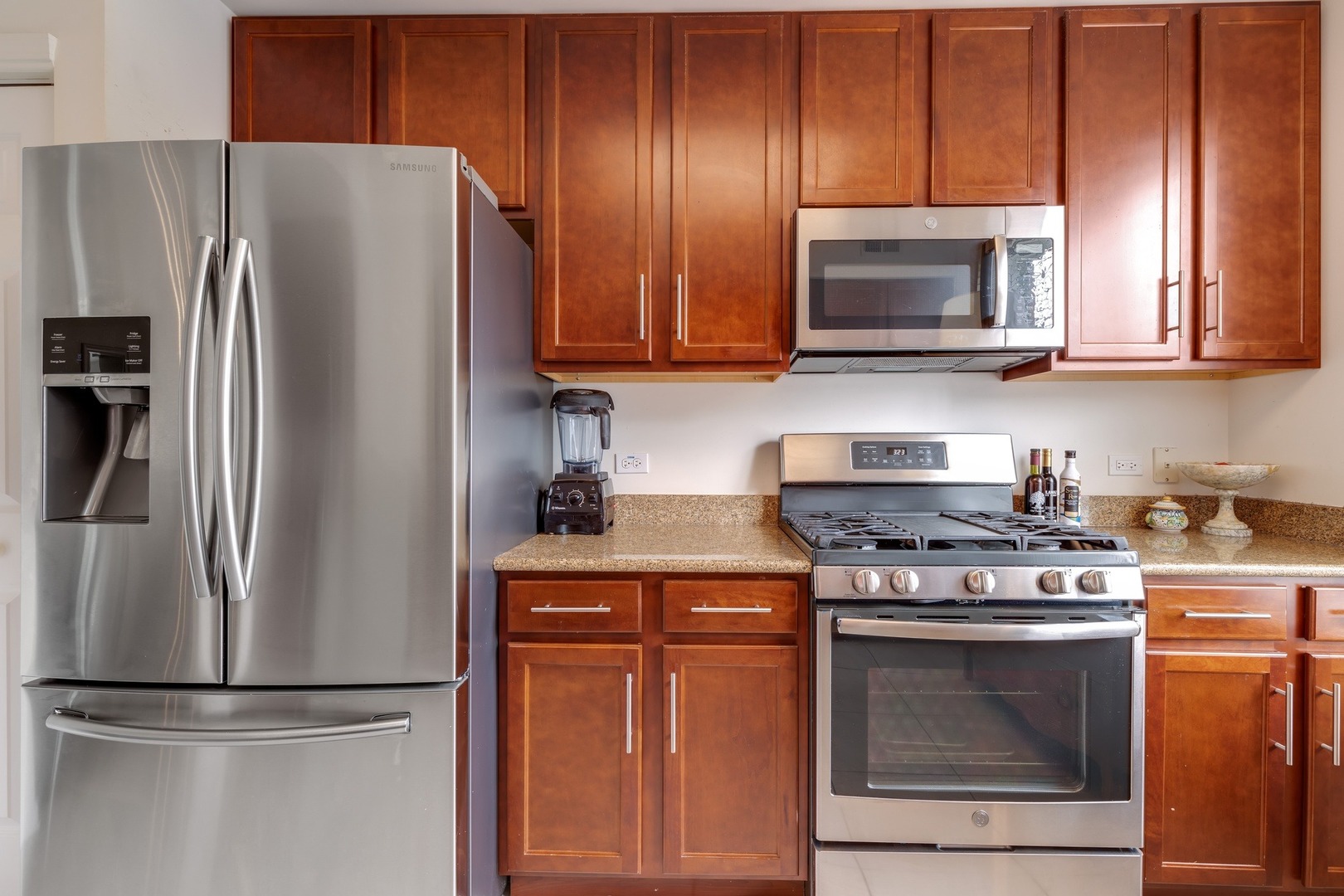 2935 Central Street, Unit 204 Evanston, IL 60201 - Photo 18 of 29 a kitchen with stainless steel appliances granite countertop a stove top oven microwave and refrigerator