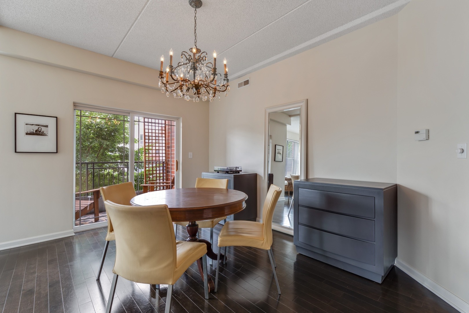 2935 Central Street, Unit 204 Evanston, IL 60201 - Photo 10 of 29 a view of a dining room with furniture a chandelier and wooden floor