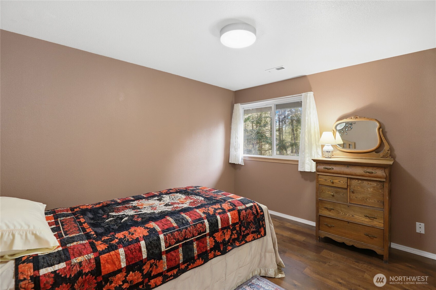 21 East Michelle Court Union, WA 98592 - Photo 23 of 33 a bedroom with a bed and wooden floor