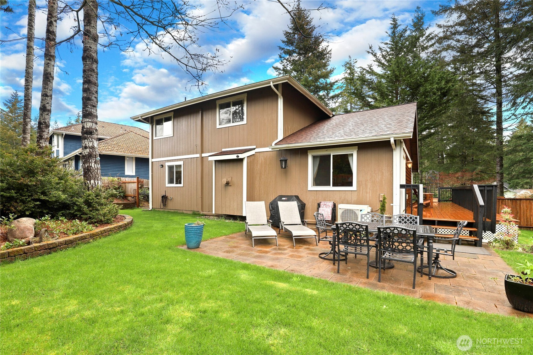 21 East Michelle Court Union, WA 98592 - Photo 24 of 33 a view of a patio with table and chairs potted plants and large tree