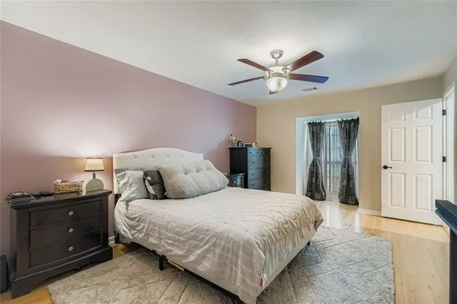 a bedroom with a large bed and a chandelier
