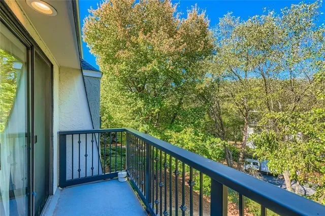 a view of a balcony with wooden fence and floor