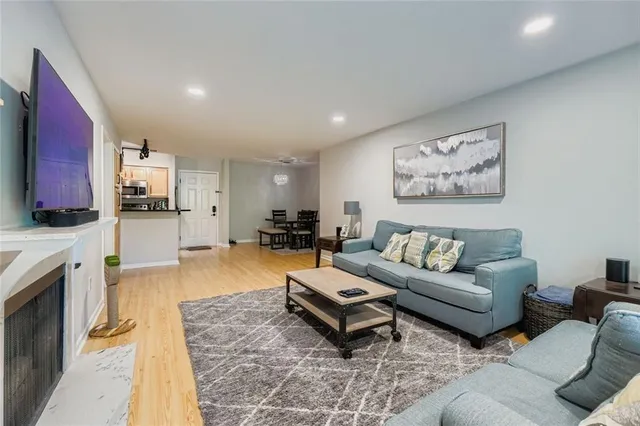 a living room with furniture and a kitchen