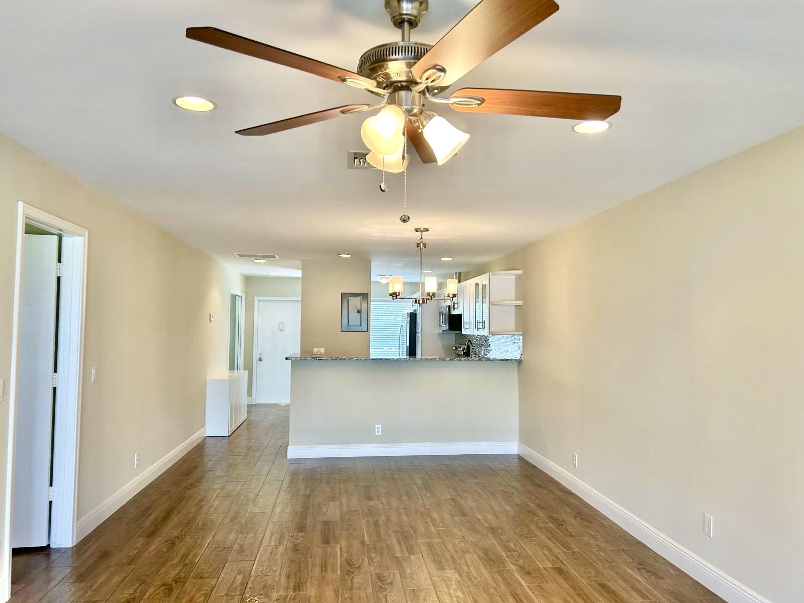 2811 Southwest 15th Street, Unit 202 Delray Beach, FL 33445 - Photo 11 of 21 a view of a kitchen with a wooden floor