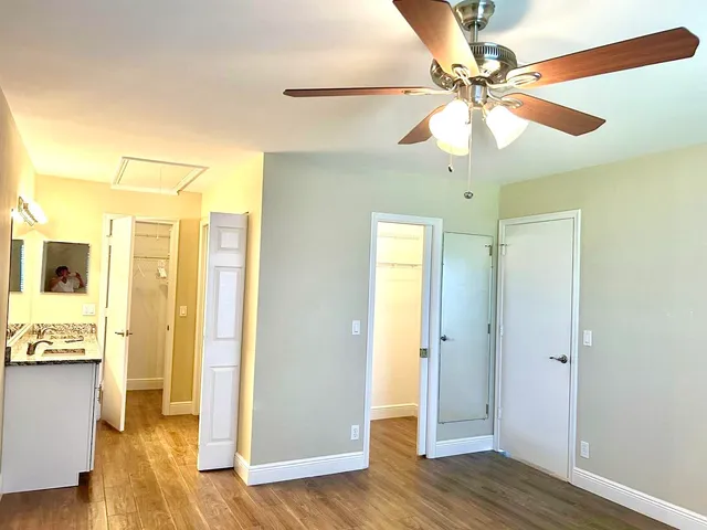 a view of a hallway with wooden floor