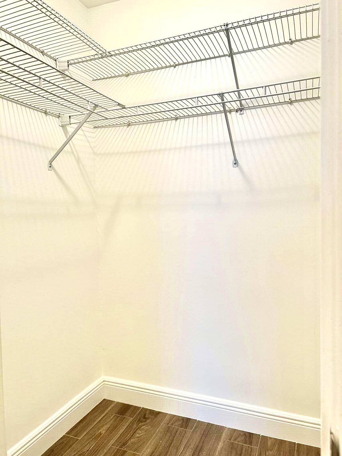 2811 Southwest 15th Street, Unit 202 Delray Beach, FL 33445 - Photo 16 of 21 a view of a room with racks on the wall