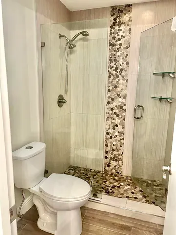 a bathroom with a toilet and shower