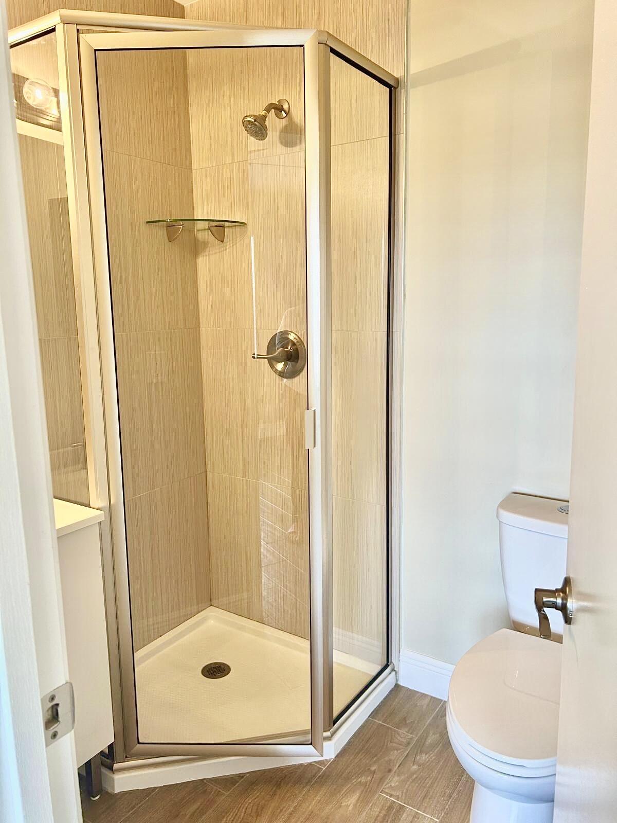 2811 Southwest 15th Street, Unit 202 Delray Beach, FL 33445 - Photo 19 of 21 a bathroom with a shower and a sink