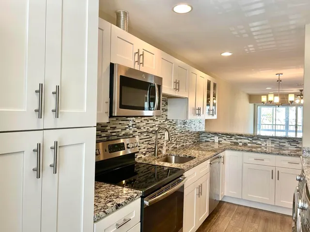 a kitchen with a sink stove and microwave