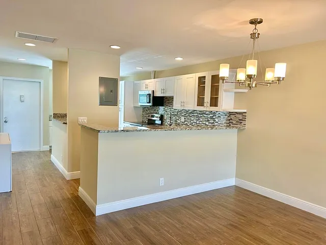 a view of a kitchen cabinets and chandelier
