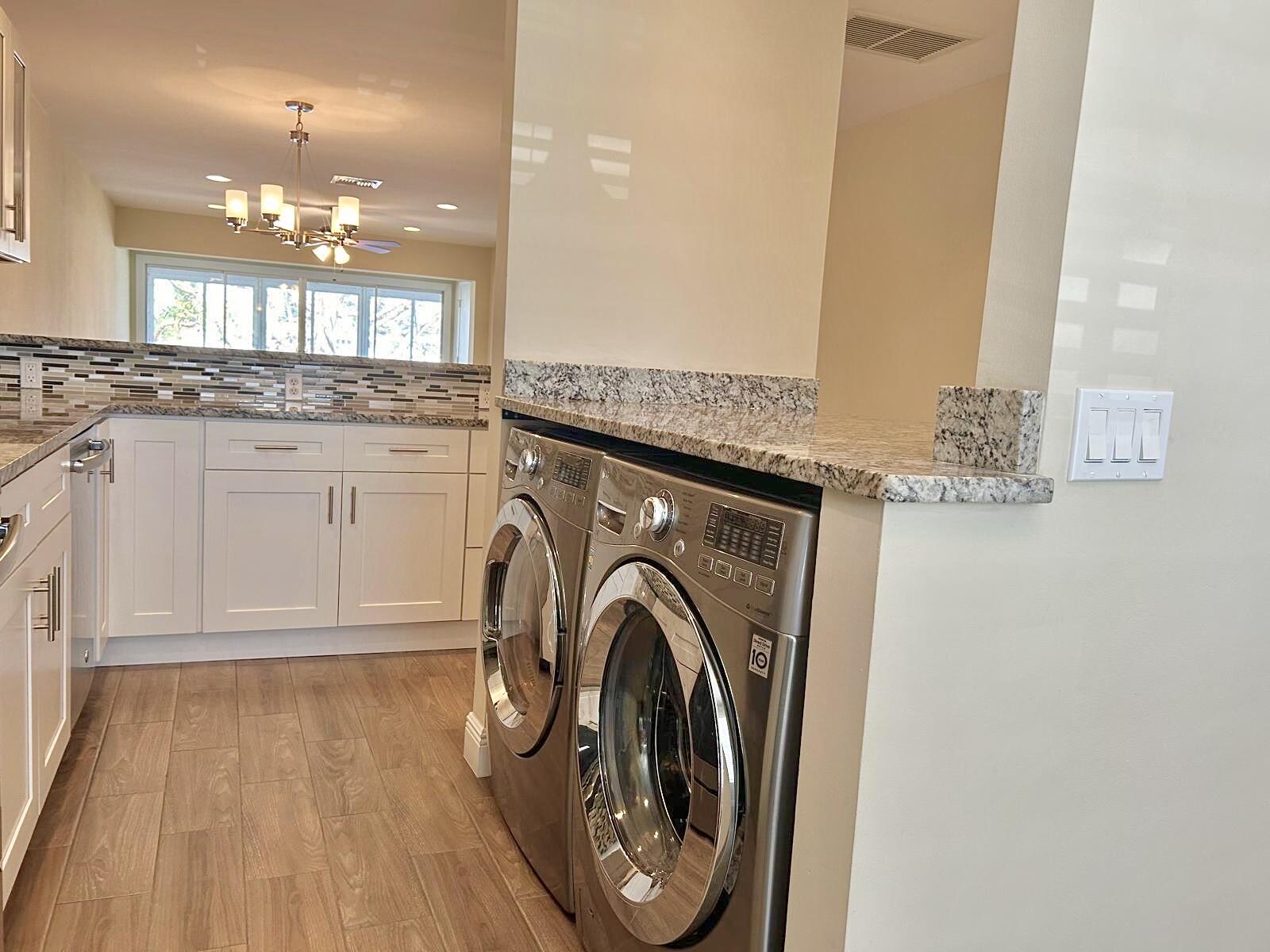 2811 Southwest 15th Street, Unit 202 Delray Beach, FL 33445 - Photo 8 of 21 a view of a hallway with washer and dryer