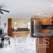 19 Madison Drive Helmetta, NJ 08828 - Photo 14 of 45 a view of a kitchen with kitchen island a counter top space a sink a refrigerator and a view of living room