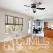 19 Madison Drive Helmetta, NJ 08828 - Photo 18 of 45 a view of a livingroom with furniture a ceiling fan and window