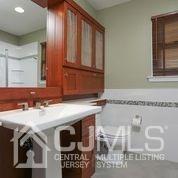 19 Madison Drive Helmetta, NJ 08828 - Photo 22 of 45 a bathroom with a sink and a mirror