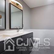 19 Madison Drive Helmetta, NJ 08828 - Photo 30 of 45 a bathroom with a sink and a mirror