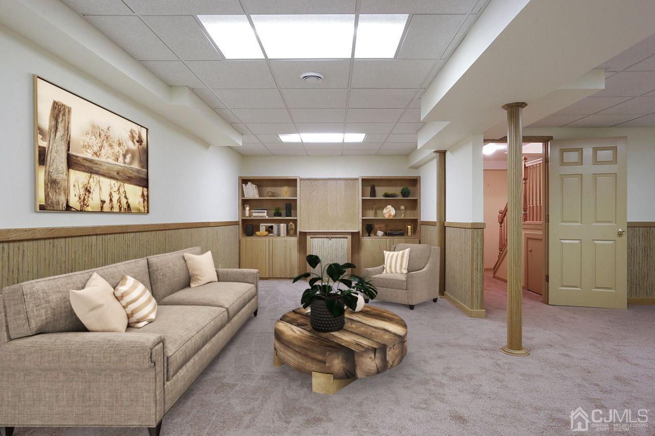 19 Madison Drive Helmetta, NJ 08828 - Photo 39 of 45 a living room with furniture kitchen view and a chandelier