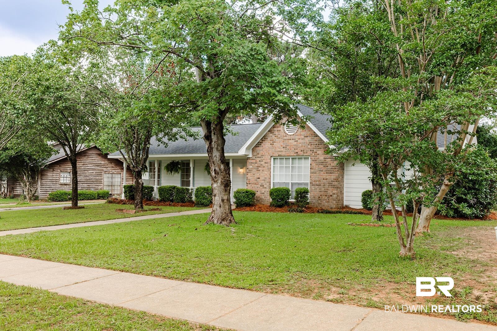 2920 Quail Creek Run Mobile, AL 36695 - Photo 3 of 33 View of front of house with a front lawn, brick siding, and a shingled roof