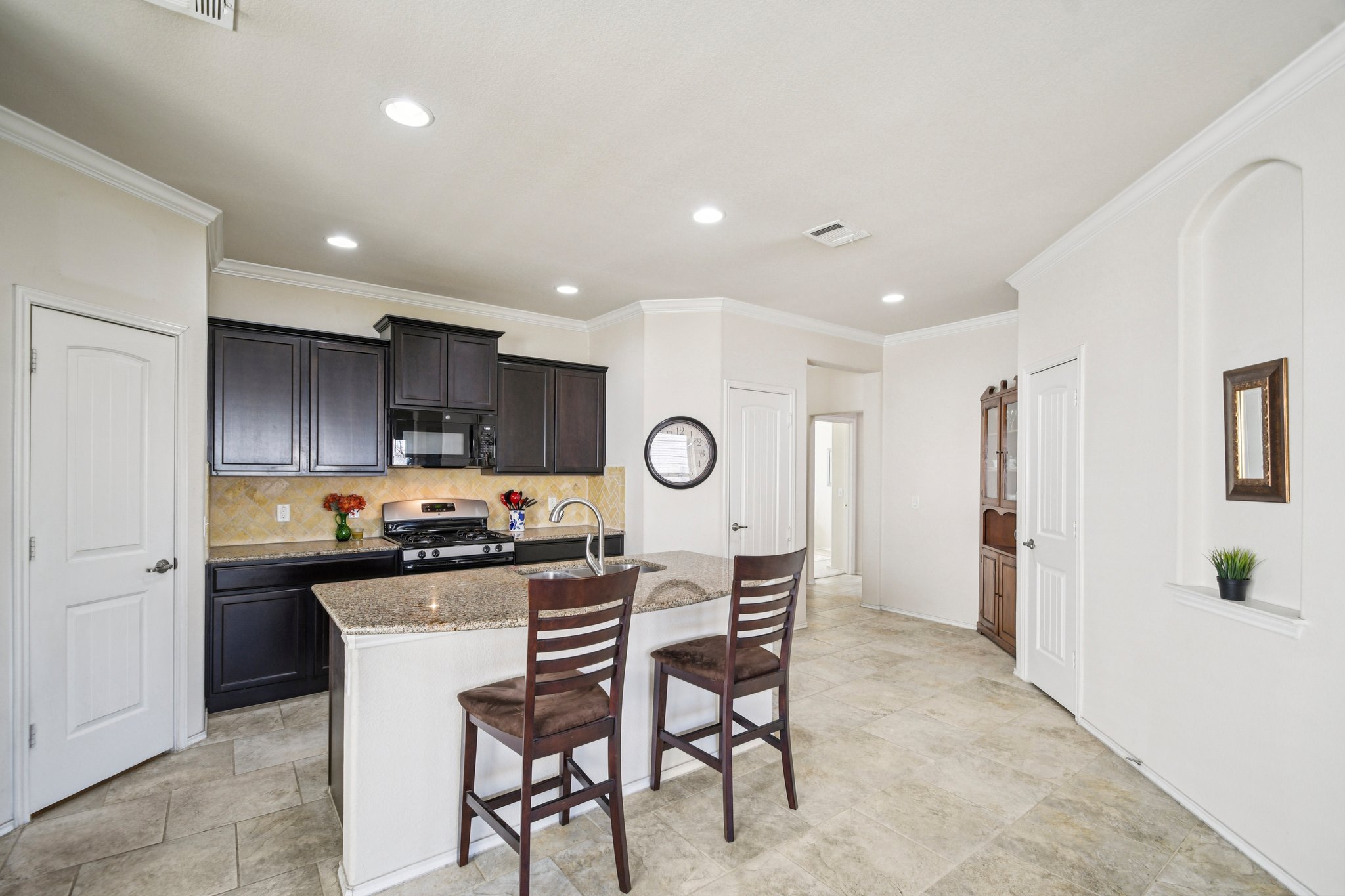 10221 Pinnacle Crest Loop Austin, TX 78747 - Photo 5 of 19 a view of a kitchen with a dining table and chairs
