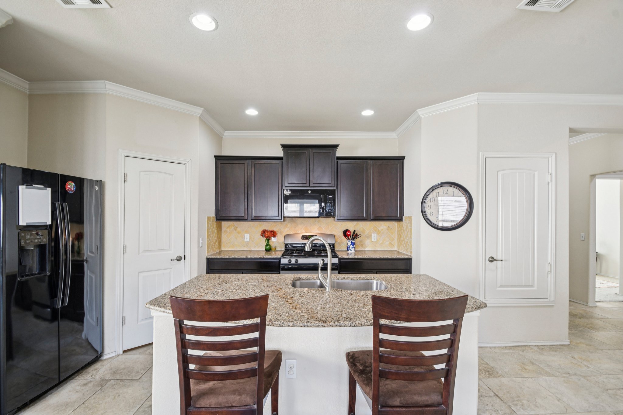 10221 Pinnacle Crest Loop Austin, TX 78747 - Photo 6 of 19 a kitchen with stainless steel appliances granite countertop a stove and a refrigerator