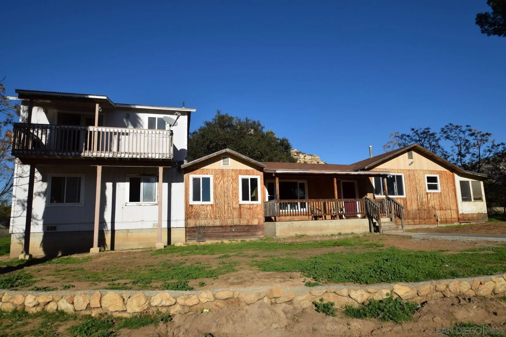 5557 Rainbow Creek Road Fallbrook, CA 92028 - Photo 1 of 24 a front view of a house with garden