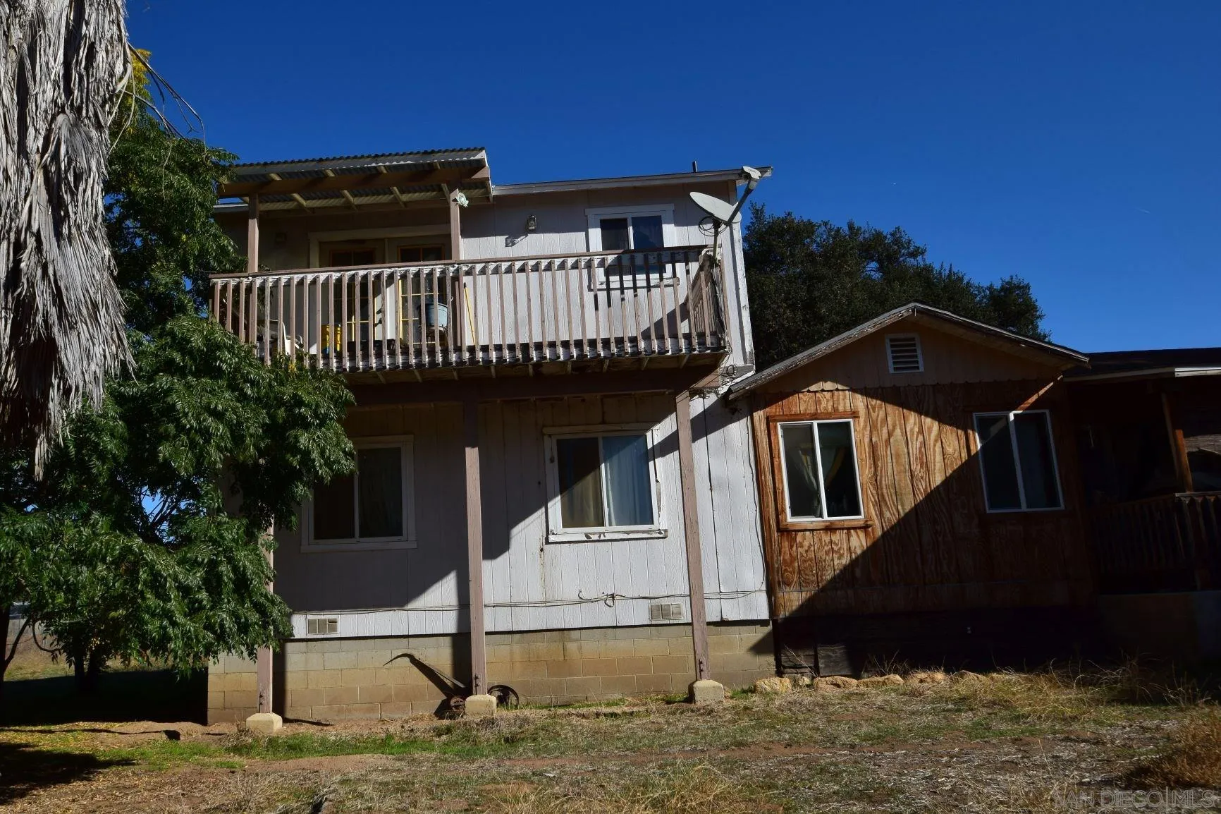5557 Rainbow Creek Road Fallbrook, CA 92028 - Photo 3 of 24 a view of a house with wooden fence