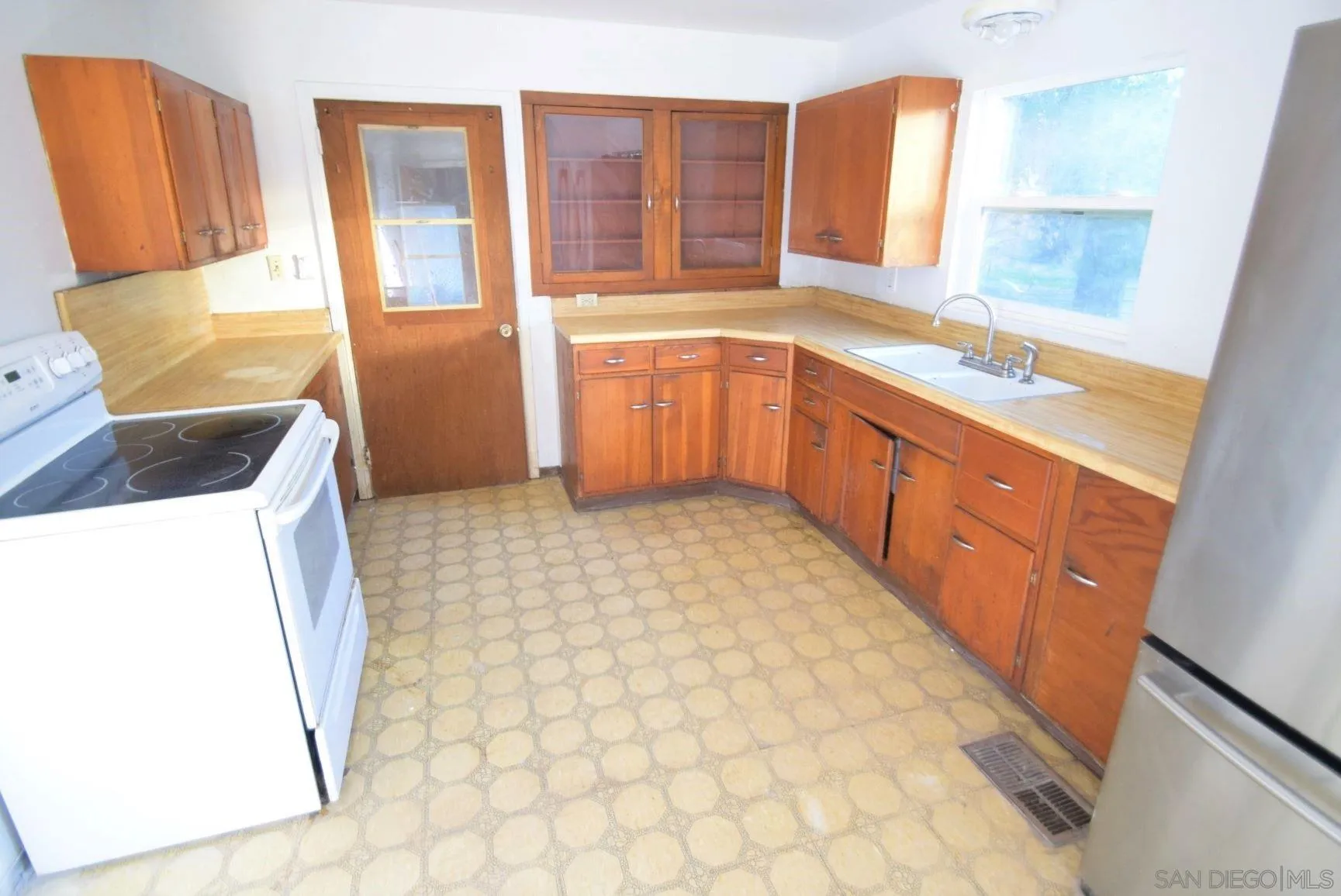 5557 Rainbow Creek Road Fallbrook, CA 92028 - Photo 4 of 24 a large kitchen with a sink a large window and stainless steel appliances