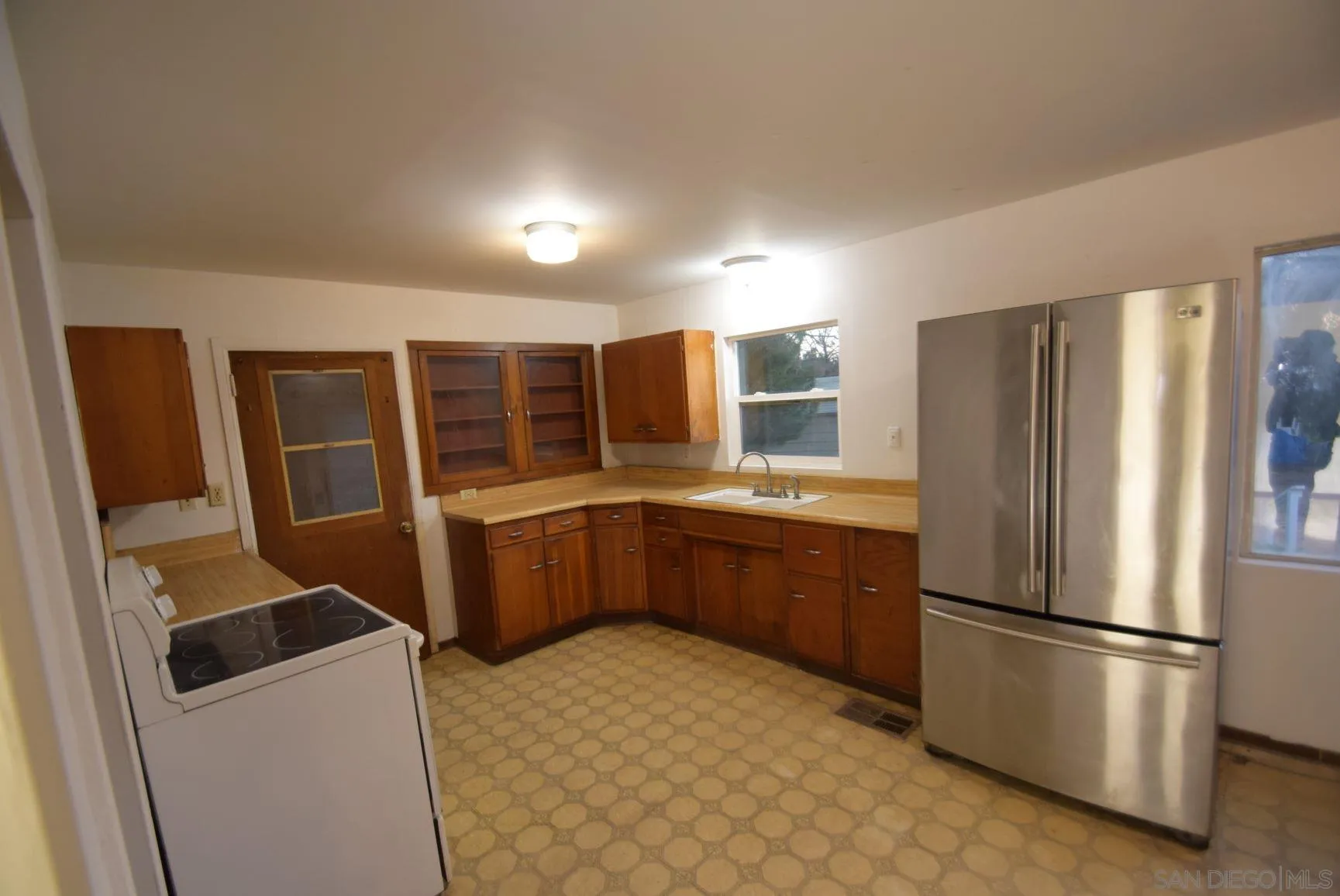 5557 Rainbow Creek Road Fallbrook, CA 92028 - Photo 6 of 24 a kitchen with stainless steel appliances a refrigerator and wooden cabinets