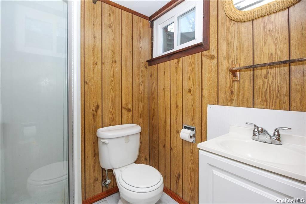26 Montrose Point Road Montrose, NY 10548 - Photo 13 of 20 a bathroom with a sink a toilet and shower curtain