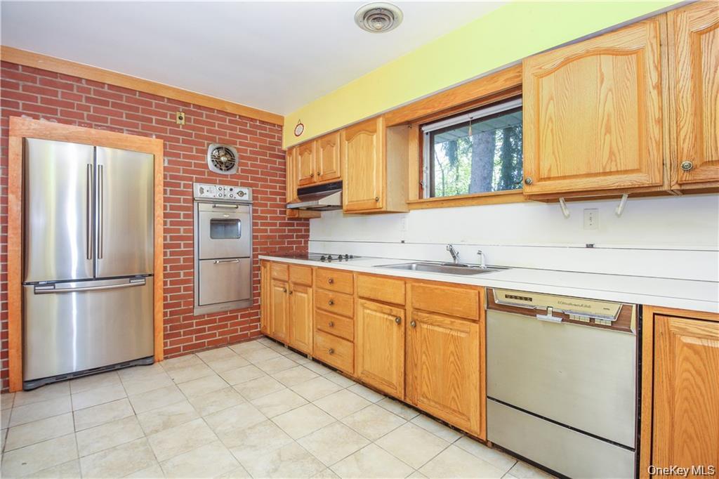 26 Montrose Point Road Montrose, NY 10548 - Photo 3 of 20 a kitchen with stainless steel appliances granite countertop a refrigerator sink and cabinets