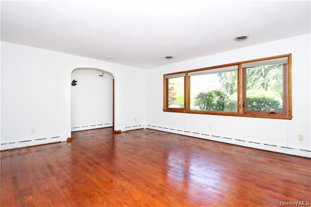 26 Montrose Point Road Montrose, NY 10548 - Photo 8 of 20 an empty room with wooden floor and windows