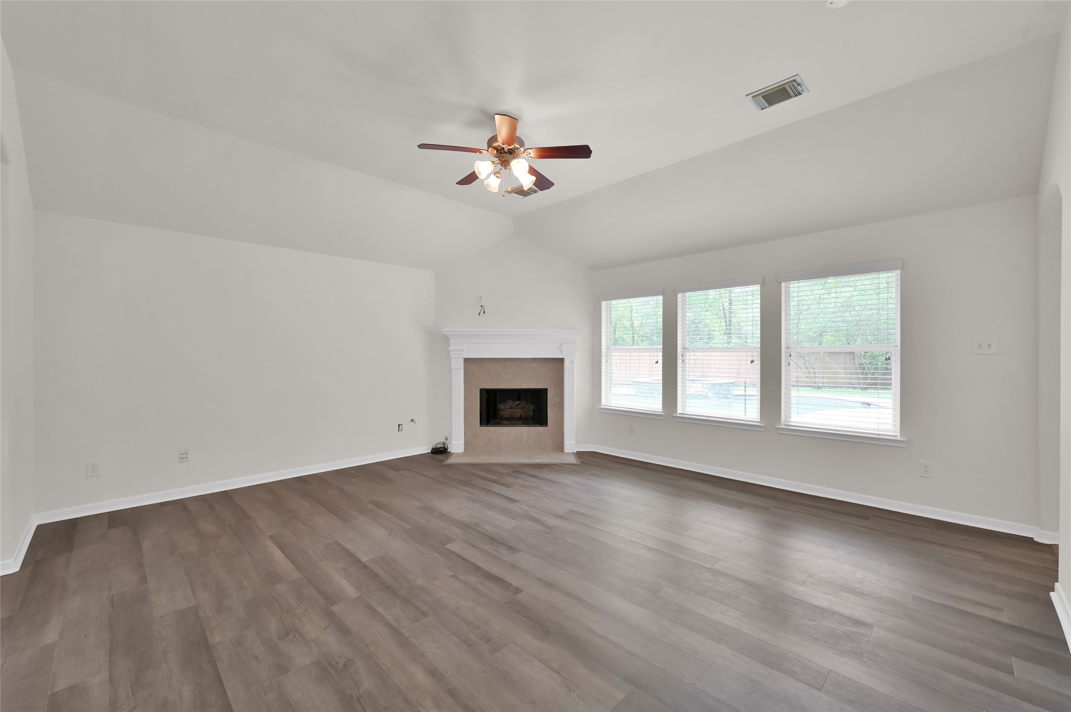 10 Barker Ridge Court Spring, TX 77382 - Photo 11 of 29 wooden floor in an empty room with a window