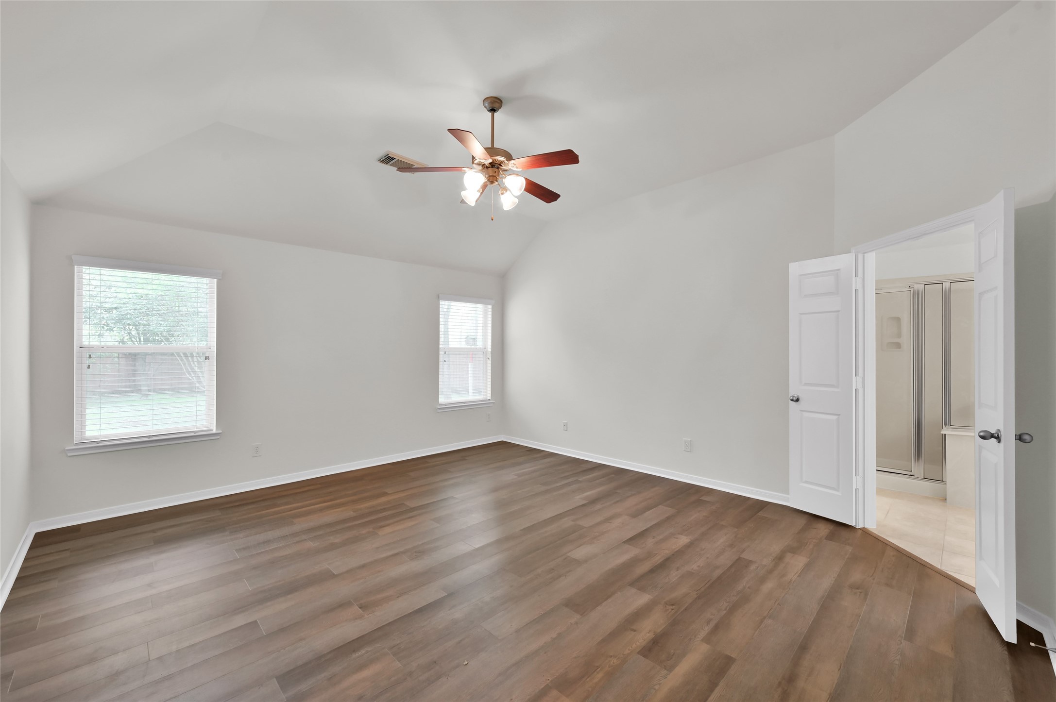10 Barker Ridge Court Spring, TX 77382 - Photo 13 of 29 an empty room with wooden floor fan and windows