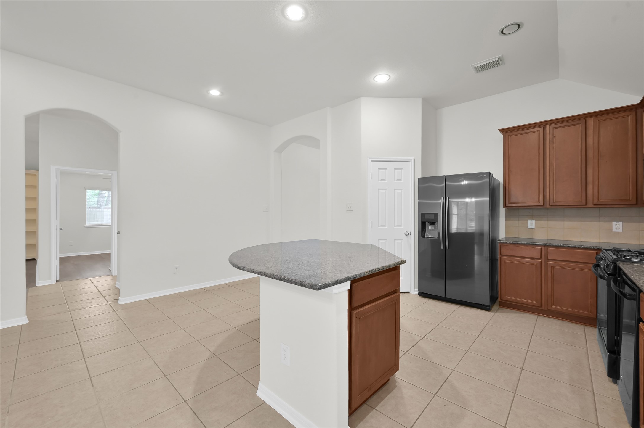 10 Barker Ridge Court Spring, TX 77382 - Photo 8 of 29 a kitchen with stainless steel appliances granite countertop a refrigerator and a stove