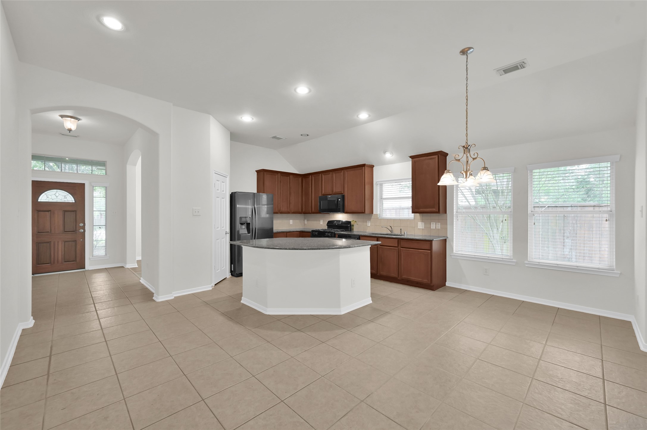 10 Barker Ridge Court Spring, TX 77382 - Photo 9 of 29 a kitchen with stainless steel appliances a refrigerator sink and microwave