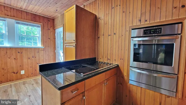a kitchen with granite countertop stainless steel appliances and wooden cabinets