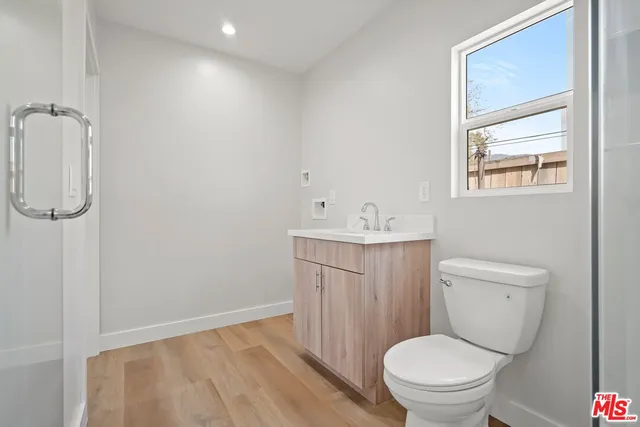 a bathroom with a toilet sink and a mirror