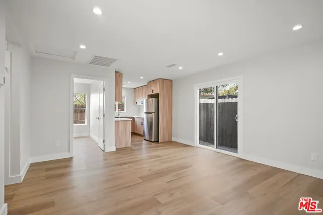 a view of a kitchen with a refrigerator and a sink