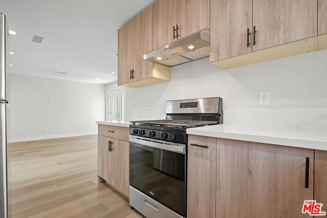a kitchen with stainless steel appliances a stove a microwave and cabinets
