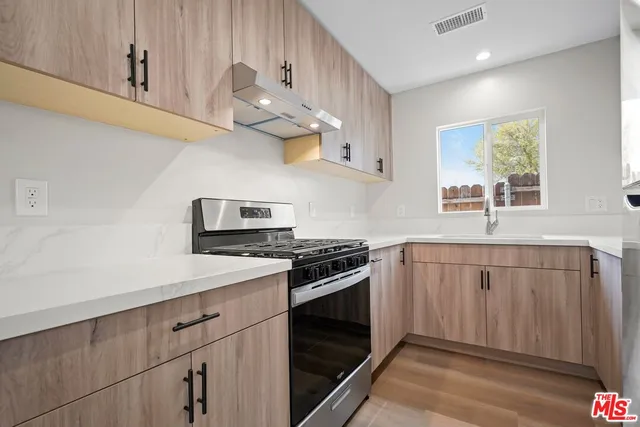 a kitchen with stainless steel appliances a sink and a stove